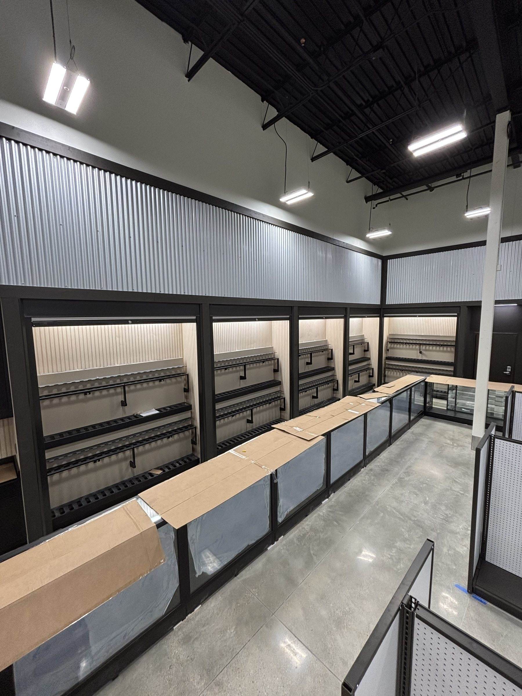 Security shutters over gun rack displays in a store