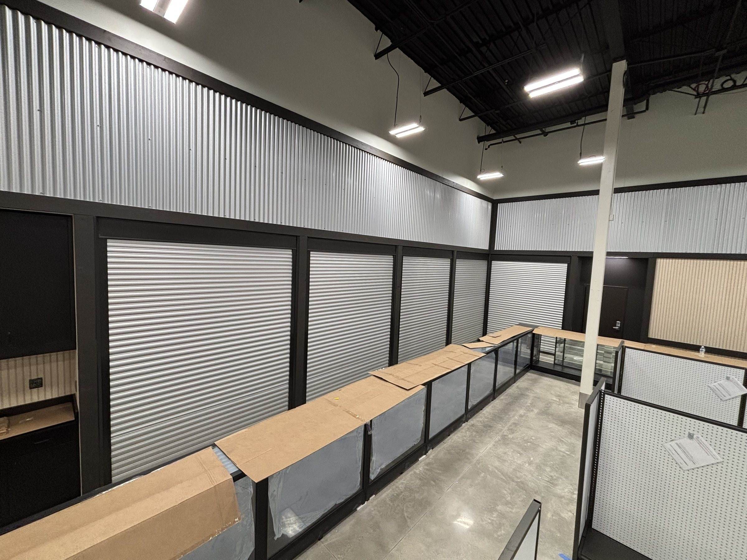 Row of closed security shutters over a retail display counter