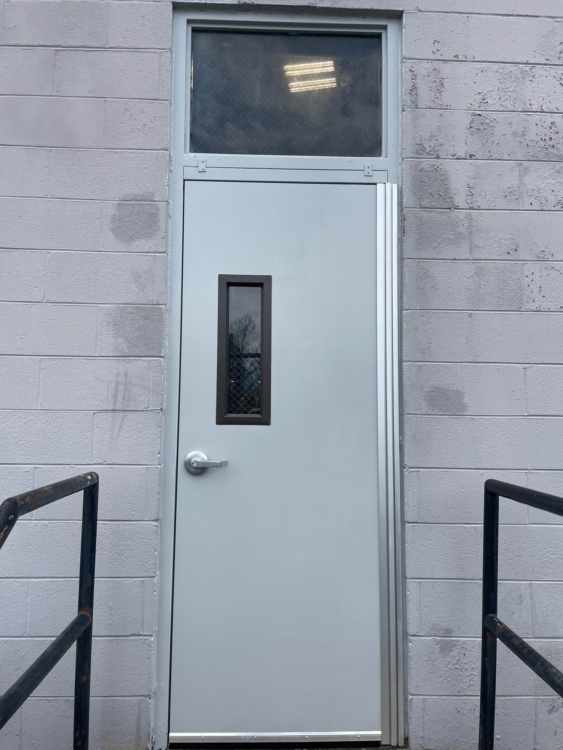 Hollow metal door with transom lite in a block wall